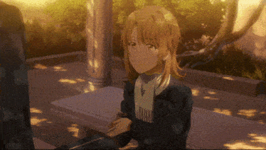 a girl with a scarf around her neck is sitting in front of a pillar
