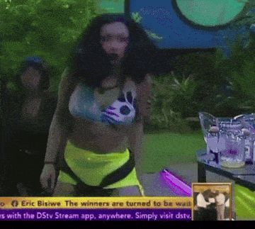 a woman in a bikini is dancing in front of a sign that says eric bisiwe the winners are turned to be wasted