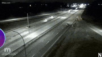 an aerial view of a highway at night with khou.com in the upper left corner