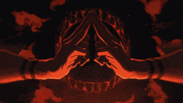 a person with their hands folded in front of a red background