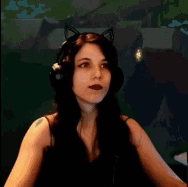 a woman wearing a cat ear headset is looking at the camera