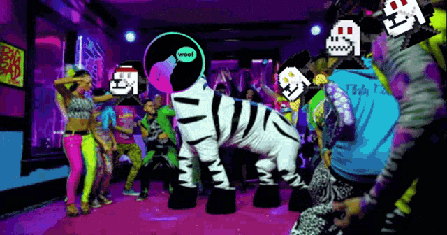 a group of people are dancing in a room with a zebra costume and a record that says woof on it
