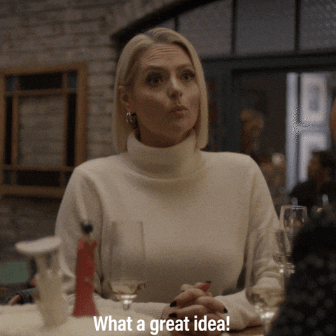 a woman sitting at a table with a glass of wine and the words what a great idea