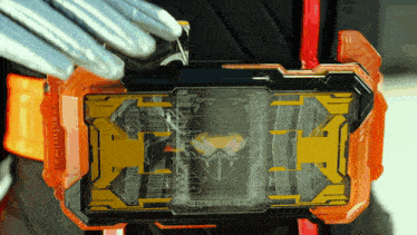 a black and orange item with the letter t on the front