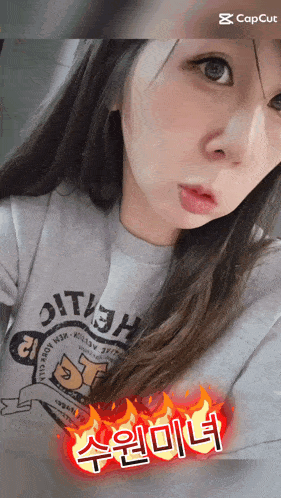 a woman wearing a shirt that says ' oth ' on it looks at the camera