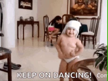 a little girl is dancing in a living room with the words `` keep on dancing ! ''