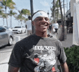 a man wearing a headband and a shirt that says bakumanma