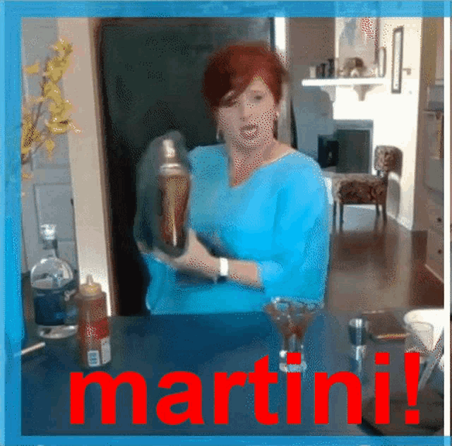 a woman in a blue shirt is shaking a martini in a glass