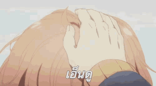 a close up of a person touching a girl 's head with a hand .