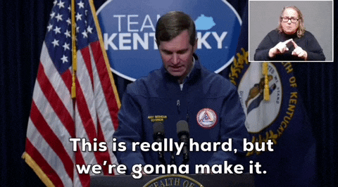 a man in front of a sign that says tea kentucky on it