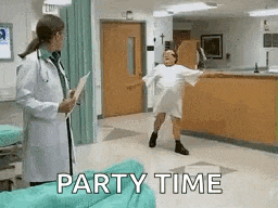 a doctor is standing next to a woman in a hospital gown dancing .