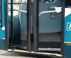 a blue bus with a handicap sign on the side of it