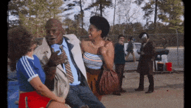 a man in a suit and tie is talking to a woman