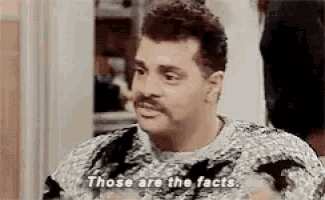 a man with a mustache is wearing a sweater and says those are the facts