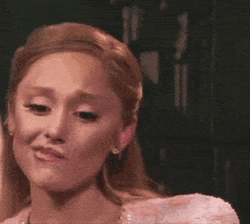 a woman in a pink dress is crying .