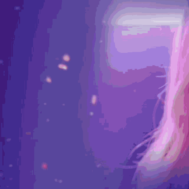 a woman sitting in a chair with a purple background