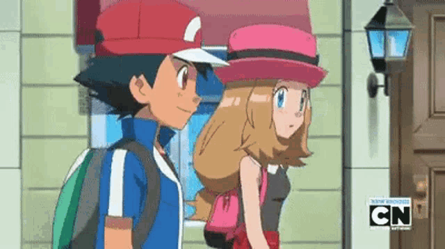a boy and a girl are standing next to each other in front of a building with cn on the bottom right corner