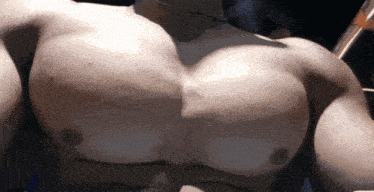 a close up of a man 's chest with a lot of muscle