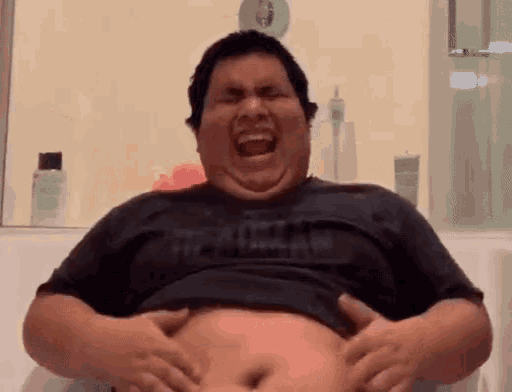a fat man in a black shirt that says the north face is laughing and holding his belly