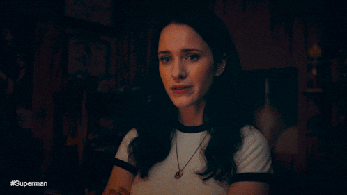 a woman 's face is shown in a dark room with the caption #superman