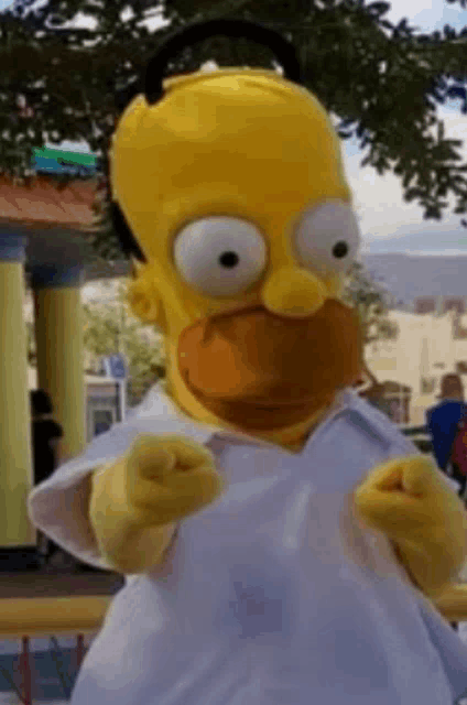 homer simpson is wearing headphones and a white shirt and is pointing at the camera .