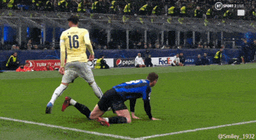 a soccer player with the number 16 on his jersey kicks the ball