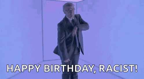 a man in a suit and tie is shouting happy birthday , racist !