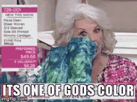 a woman covering her face with a sweater that says it 's one of gods color on it