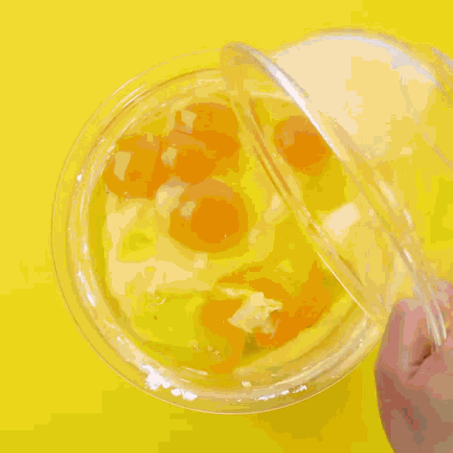 cocoa powder is being poured into a glass bowl