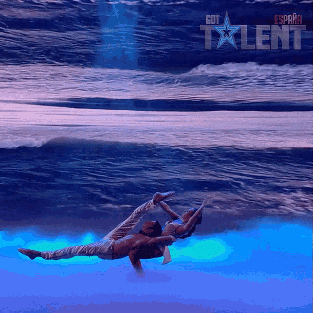 a poster for got talent shows a man and a woman performing in the water
