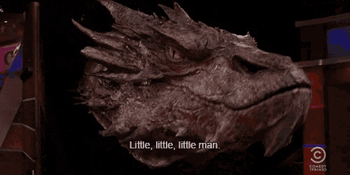 a close up of a dragon 's head with the words " little little little man lecherous lip licking noise "