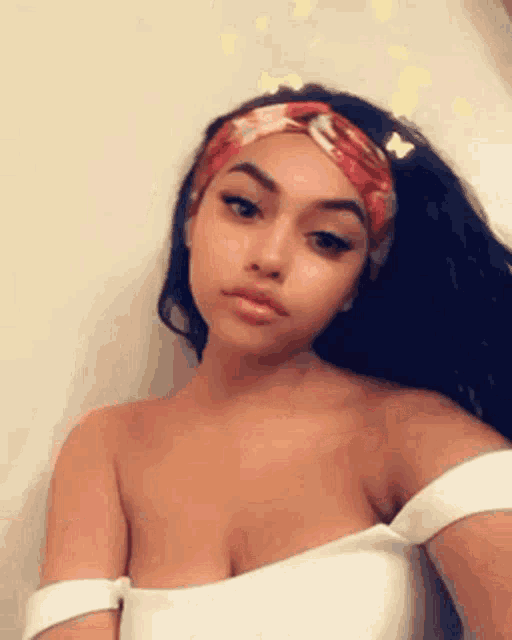 a woman wearing a headband is taking a selfie .