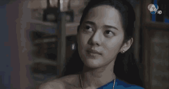 a close up of a woman 's face with the number 7 in the background