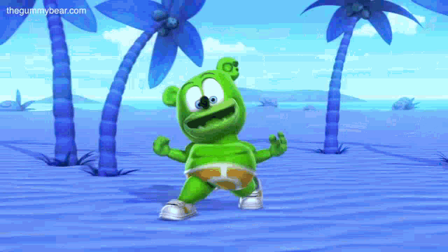 a gummy bear is dancing on a beach with palm trees .