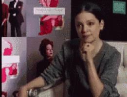 a woman is sitting in front of a wall with pictures on it and a sign that says 10th post