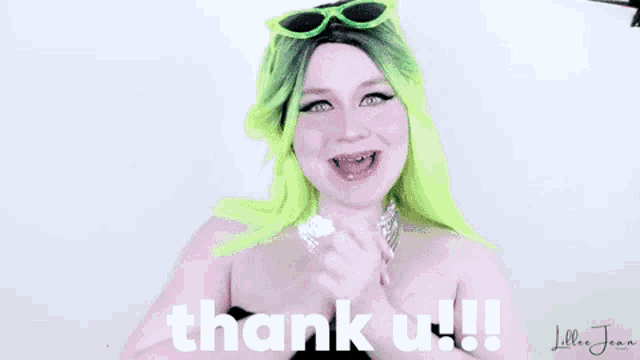 a woman with green hair and sunglasses says thank you