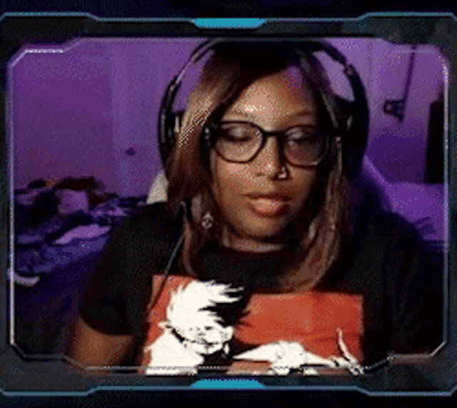 a woman wearing headphones and glasses is sitting in front of a computer screen