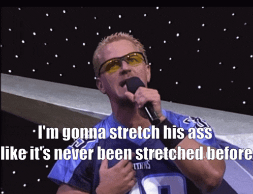 a man in a titans jersey holds a microphone and says i 'm gonna stretch his ass
