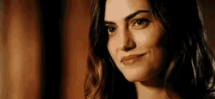a close up of a woman 's face smiling .