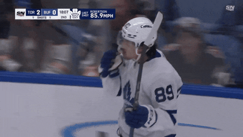 a hockey player with the number 89 on his jersey stands on the ice