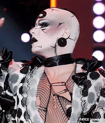 a close up of a person wearing a black and white polka dot outfit