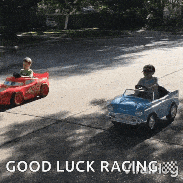 two young boys are driving toy cars on a street with the words " good luck racing " on the bottom