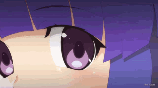 a close up of a girl 's face with purple eyes