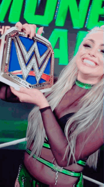 a woman is holding a wwe championship belt