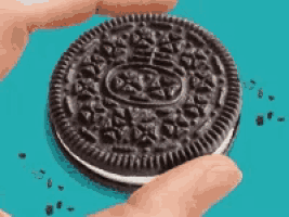 a close up of a person holding an oreo cookie