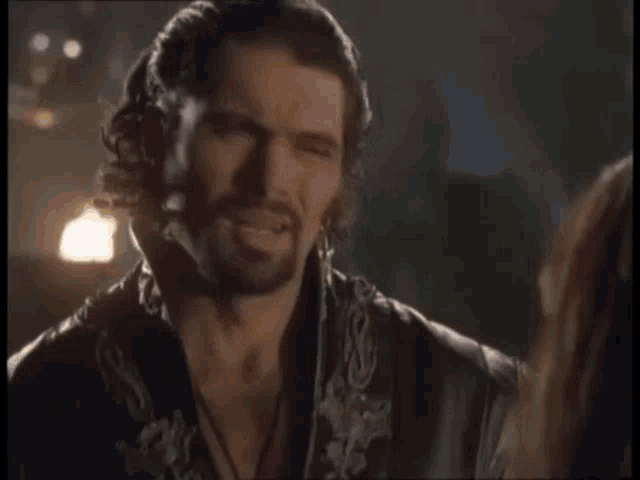 a man with a beard is talking to a woman and says " not now xena "