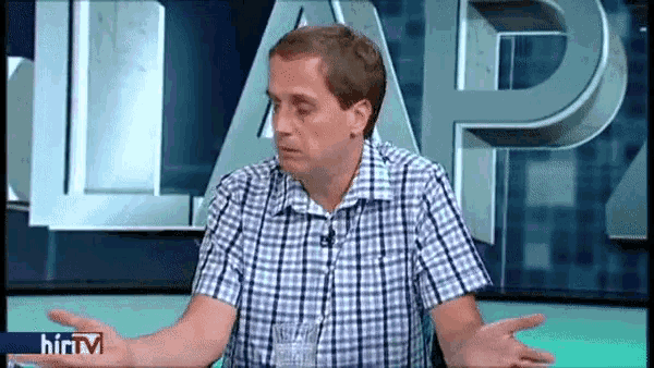 a man in a plaid shirt is sitting in front of a sign that says ' lap '