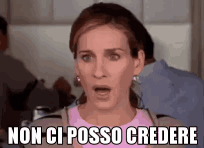 a woman is making a funny face with her mouth open and the words `` non ci posso credere '' written on her face .