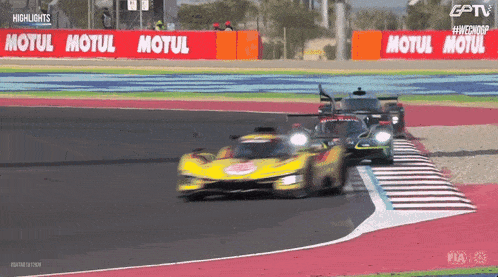 a race car is on a track with a motul sign in the background
