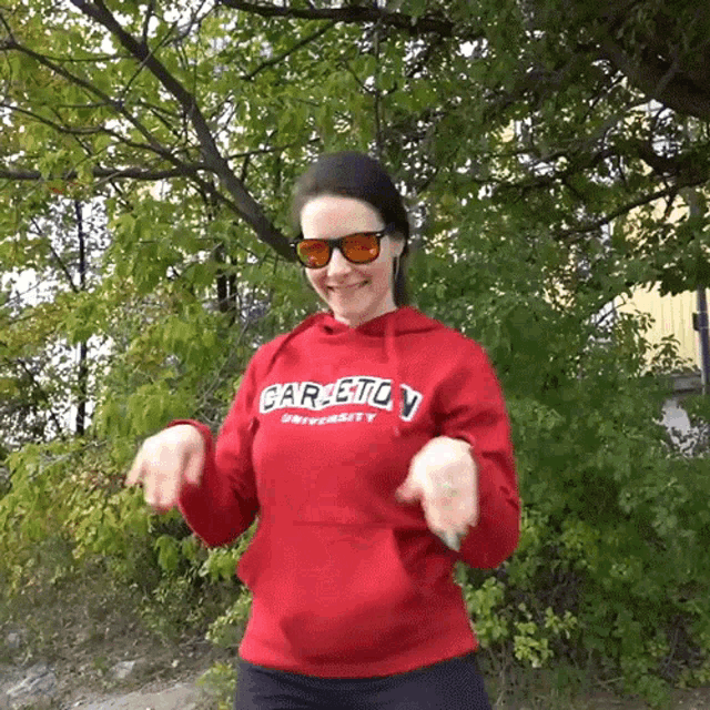 a woman wearing a red garageton university hoodie
